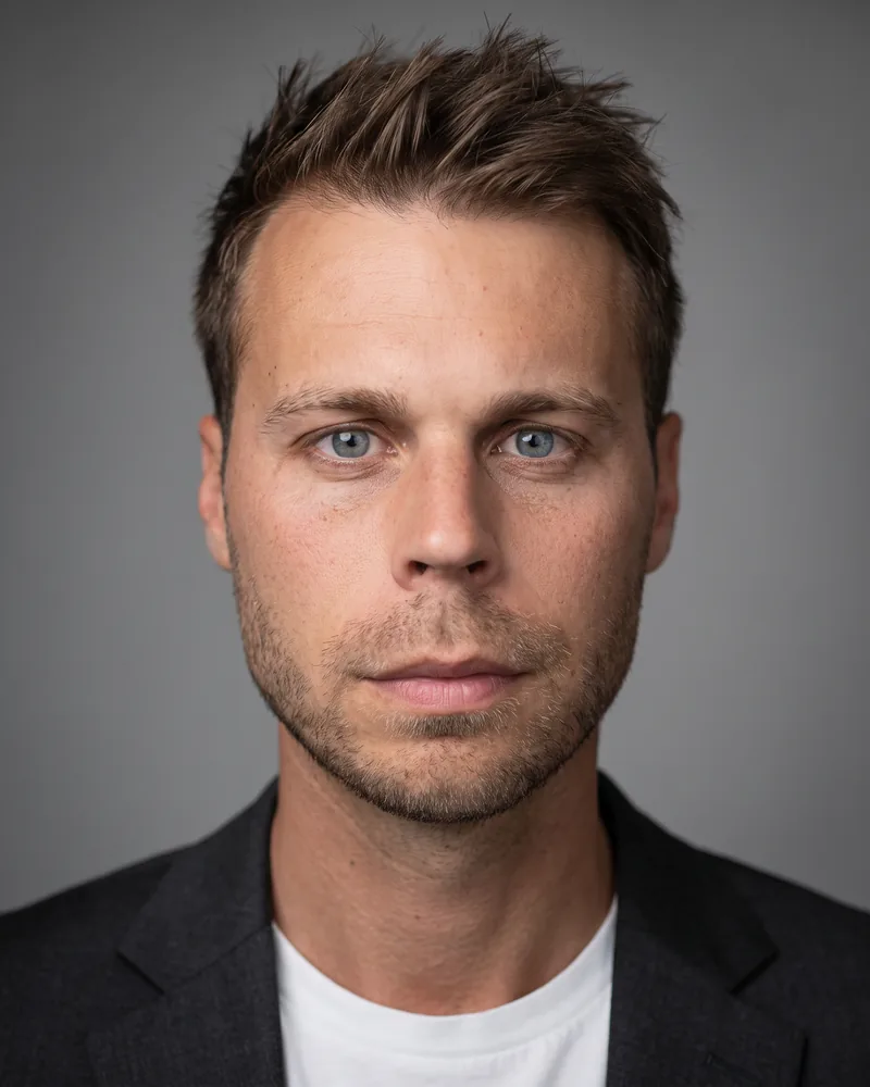 Professional headshot example generated by Staffshots — attire option: Dark blazer