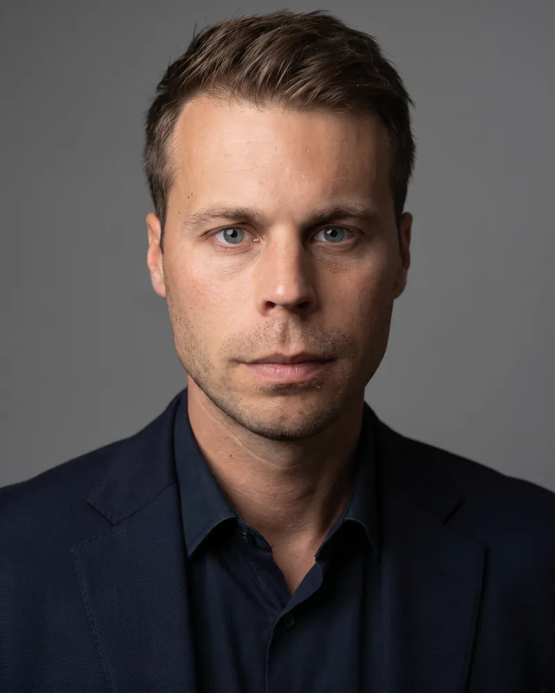 Professional headshot example generated by Staffshots in the Colour on Grey preset