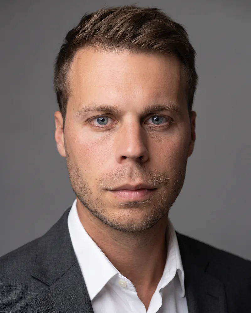 Professional headshot example generated by Staffshots in the Studio Grey preset